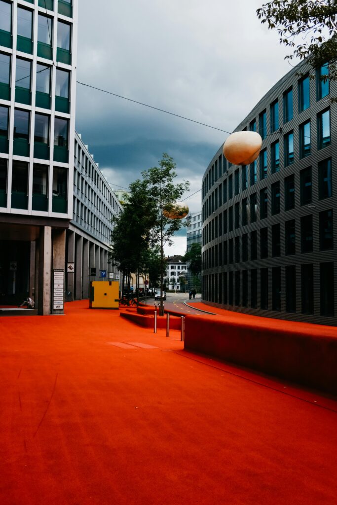 Quartier d'affaires moderne avec sol rouge en Suisse, illustrant le cadre légal de la domiciliation commerciale.